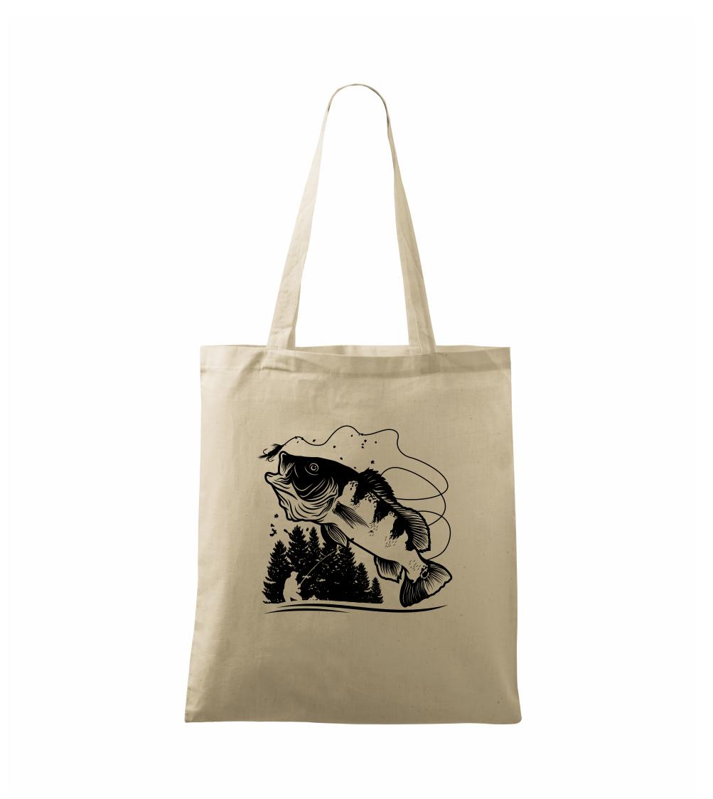 Rybár na brehu rybníka muškári