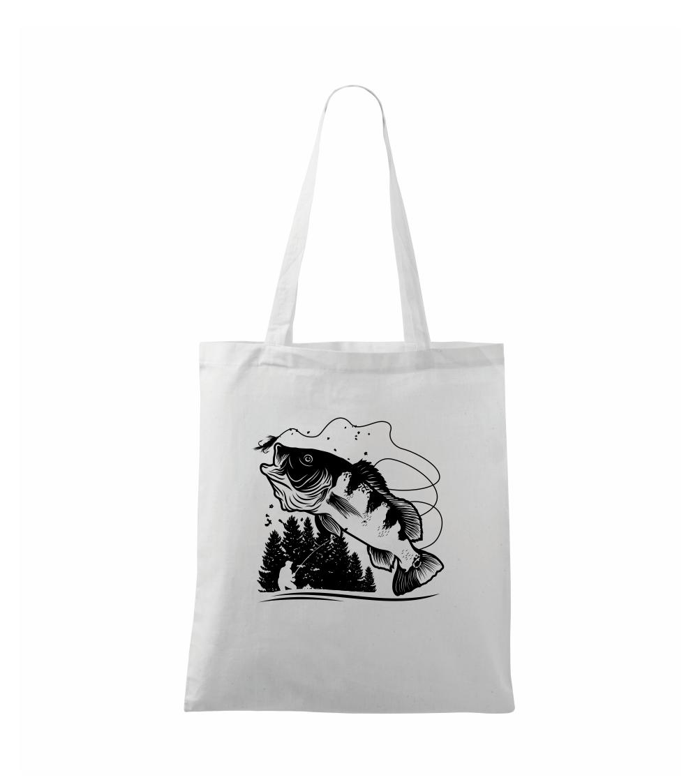 Rybár na brehu rybníka muškári