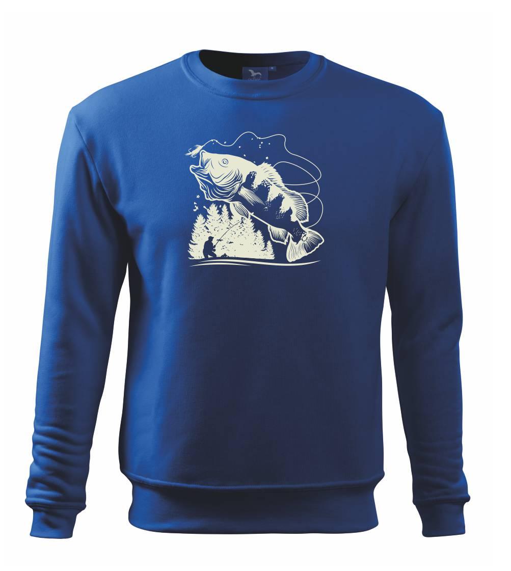 Rybár na brehu rybníka muškári