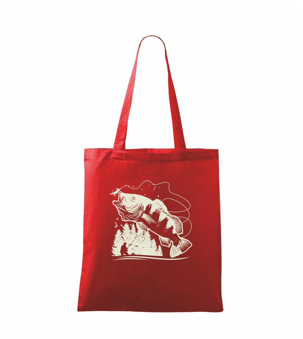 Rybár na brehu rybníka muškári