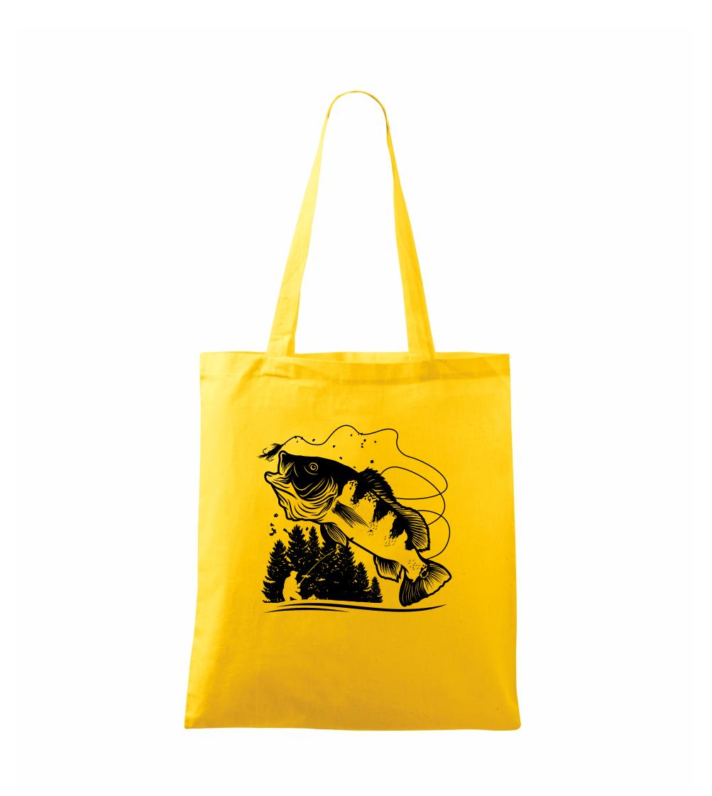 Rybár na brehu rybníka muškári