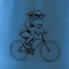 Opice s okuliarmi na bicykli