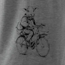 Krava v obleku na bicykli