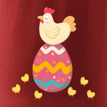 Sliepka sediaca na veľkonočnom vajci