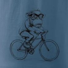 Opice s okuliarmi na bicykli